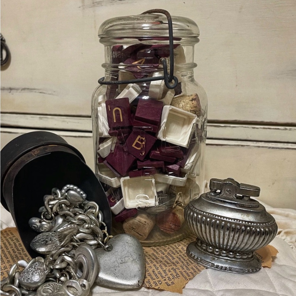 Vintage Atlas glass jar filled with maroon and white Scrabble letter tiles.